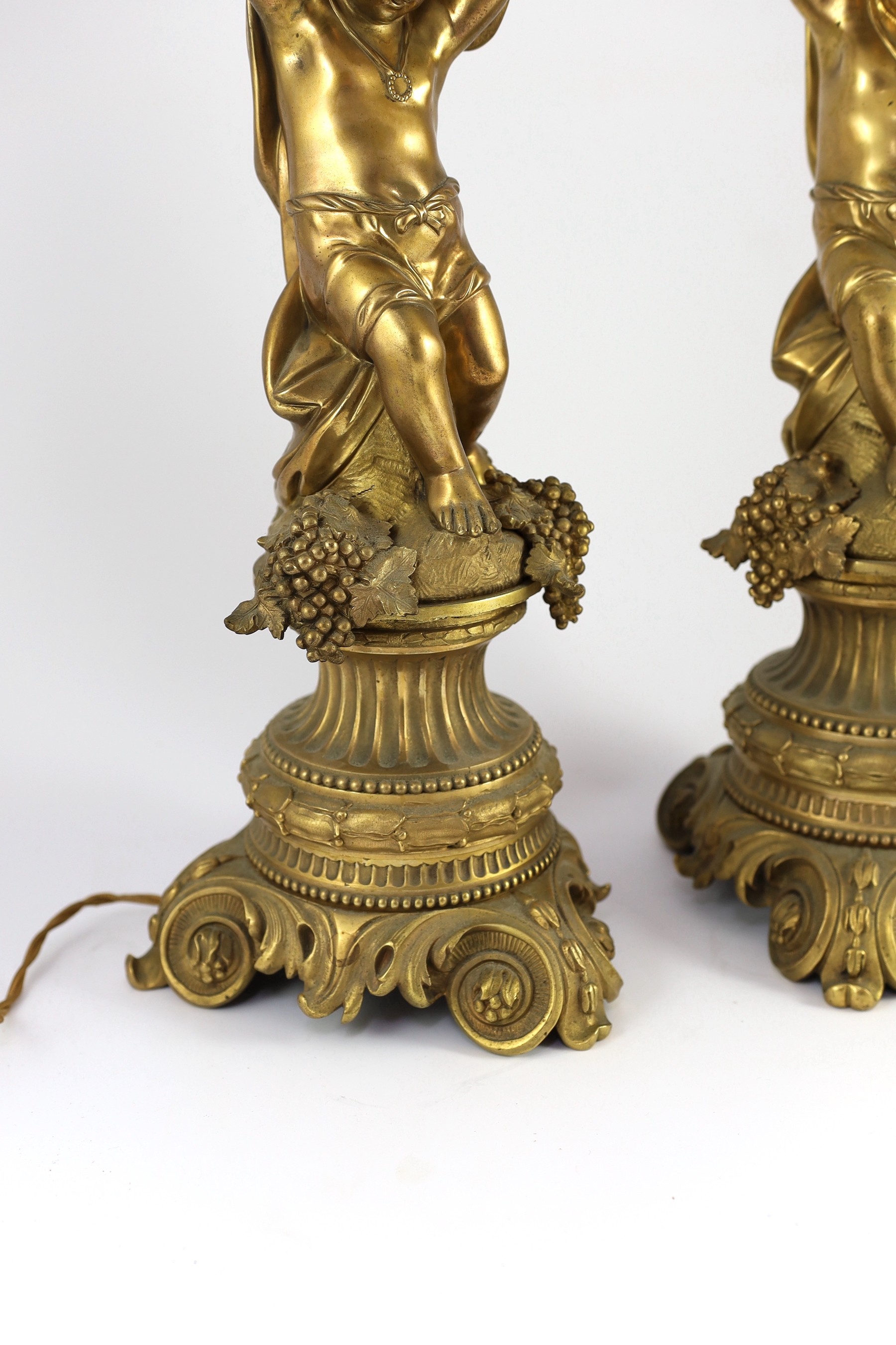 A pair of Victorian style ormolu table lamps, 50cm high to fittings